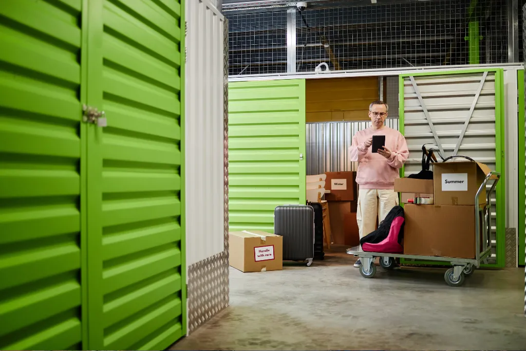 Stacked, labelled moving boxes inside a clean storage unit